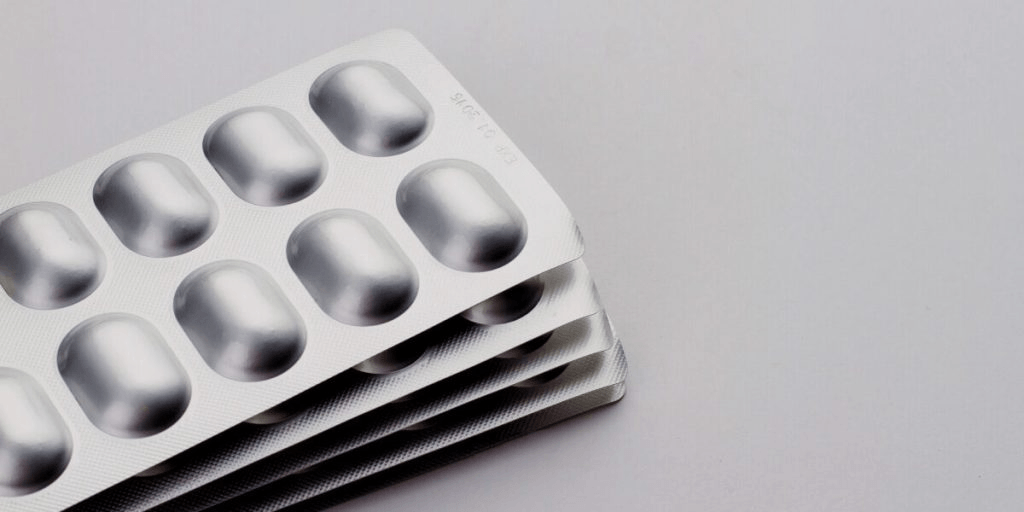 Cold-formed aluminum blister packaging providing secondary high-barrier protection for polymer pharmaceutical vials.